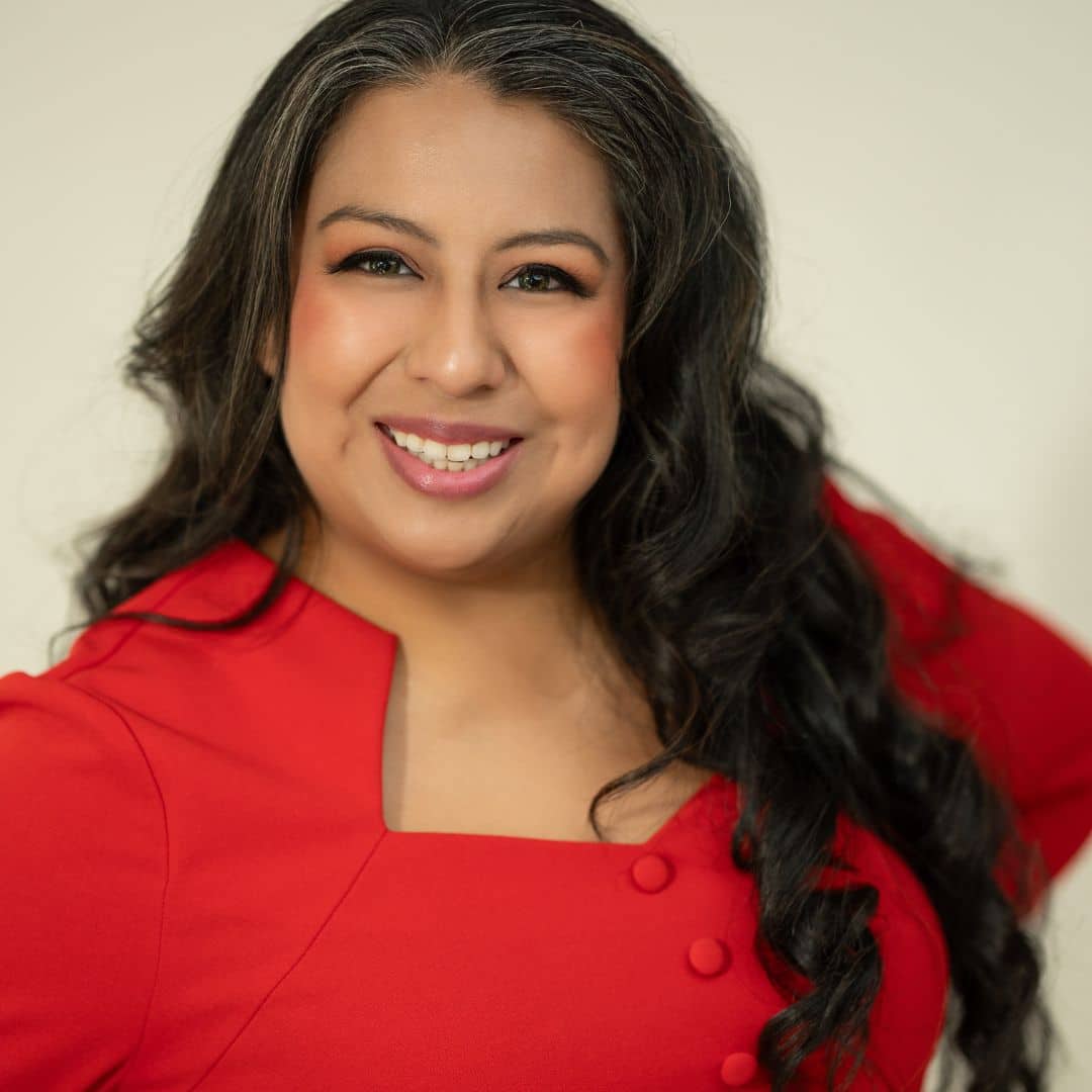 Smiling woman in red dress.