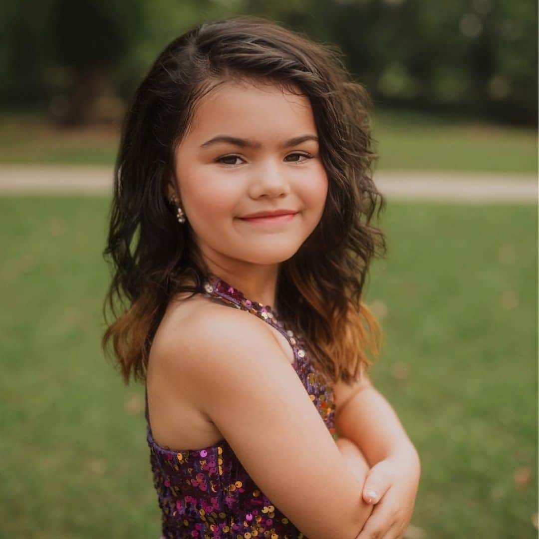 Young girl smiling in a park.