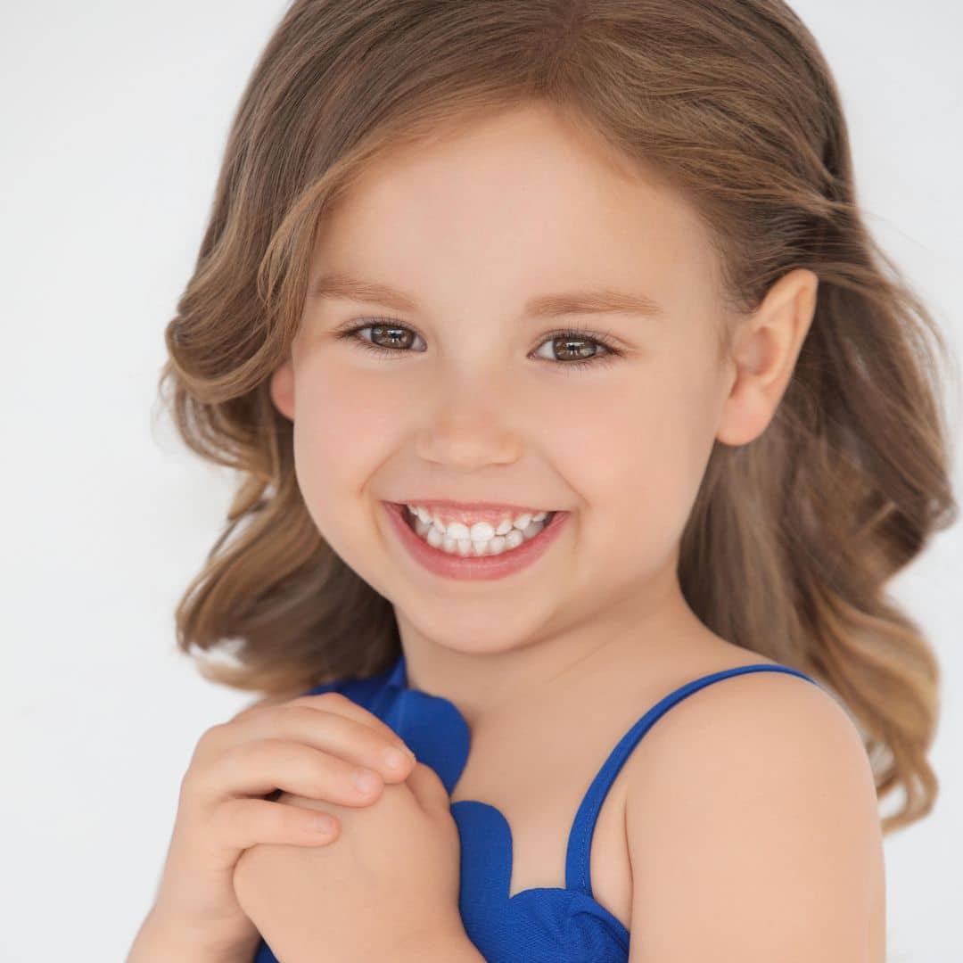 Smiling girl in blue dress