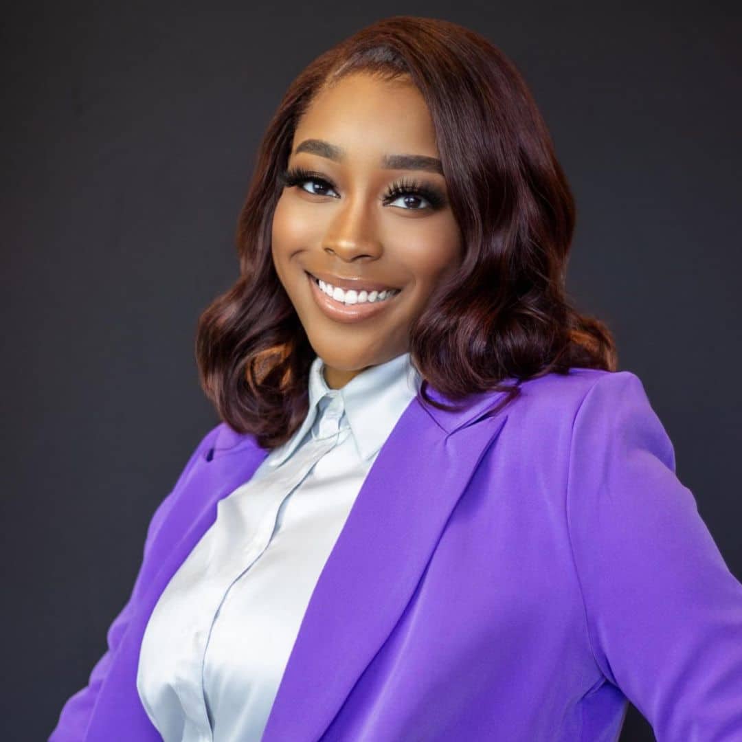 Smiling woman in purple blazer