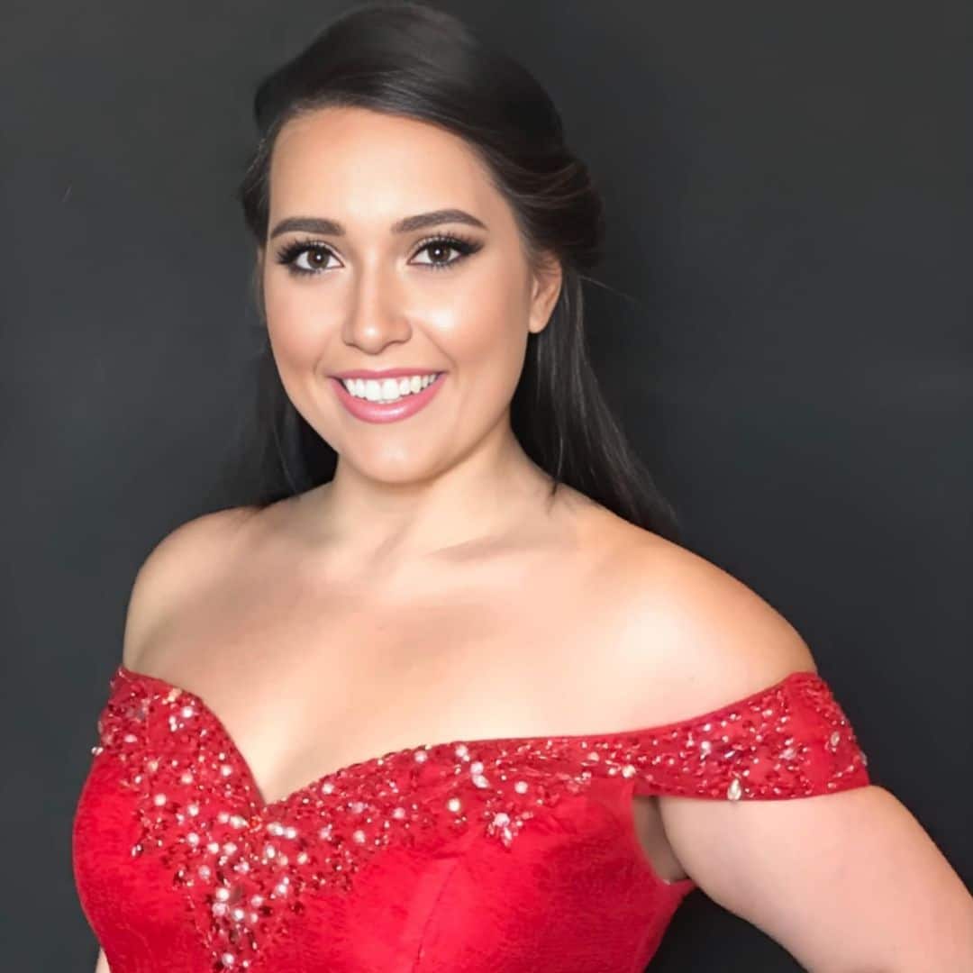 Woman in red dress smiling.