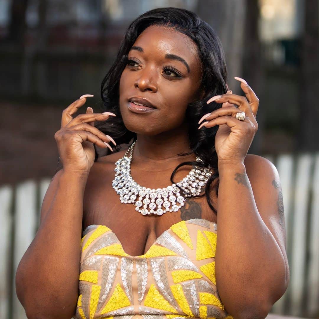 Woman posing with large diamond necklace