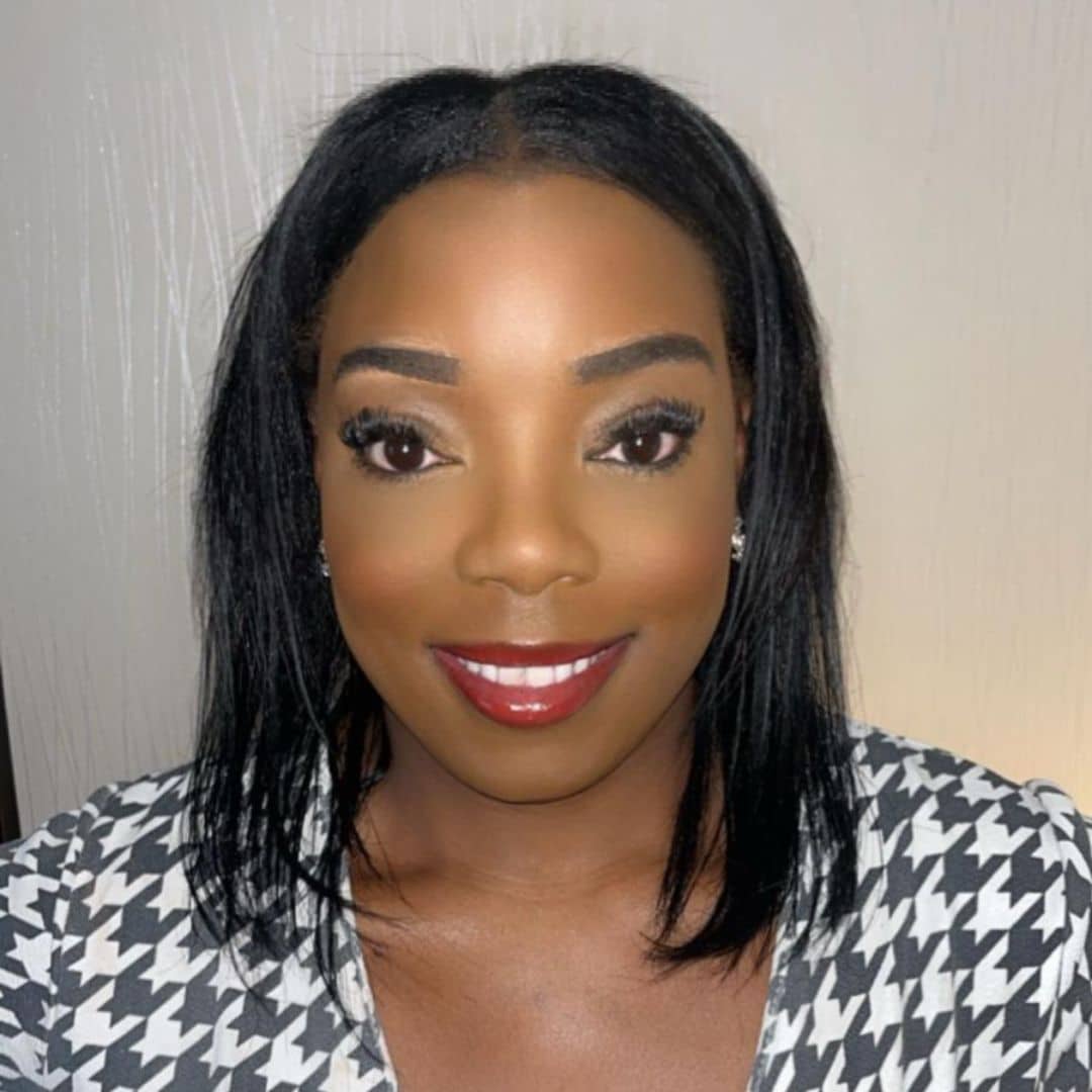 Smiling woman with black hair and red lipstick