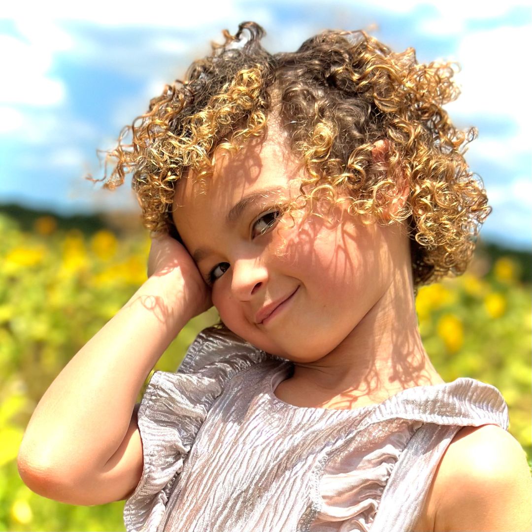 Smiling child outdoors in a sunny field