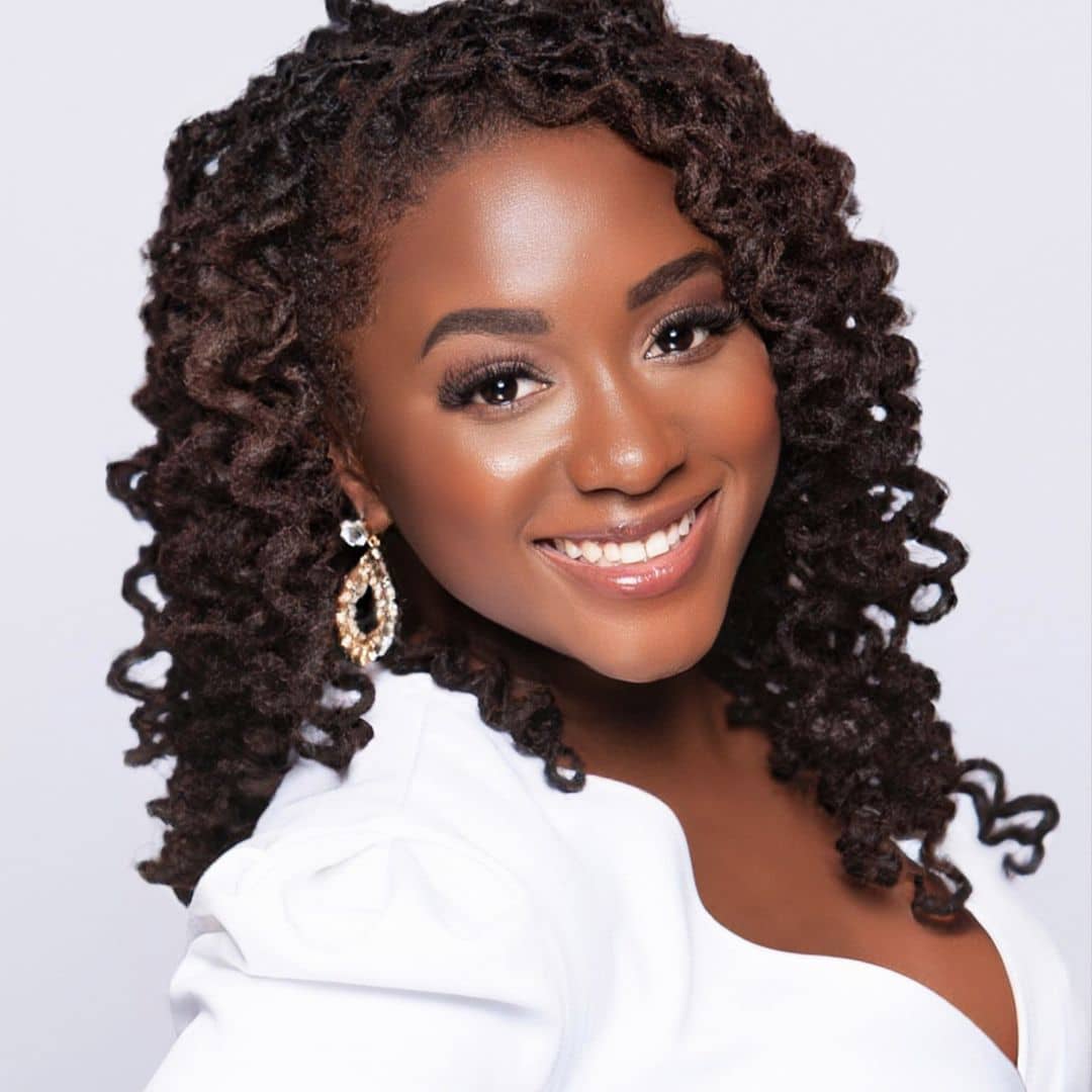 Smiling woman with curly hair and earrings