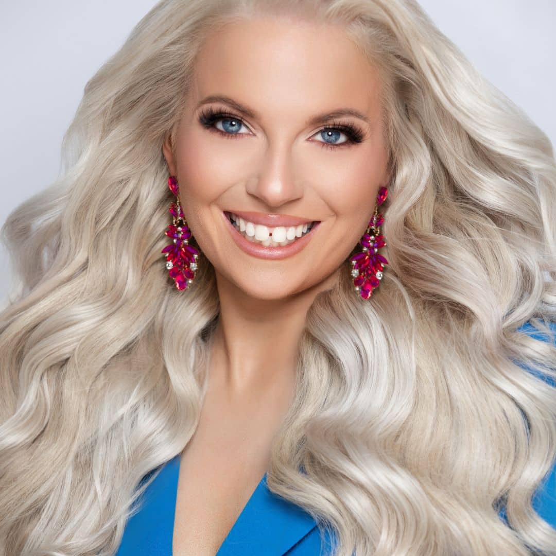 Woman with long blonde hair and pink earrings