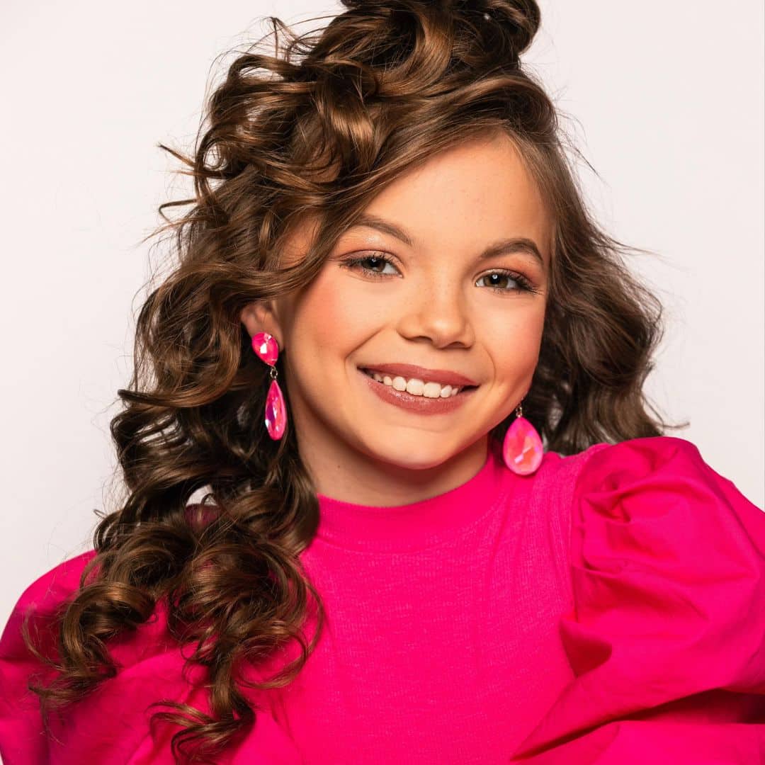 Woman in bright pink dress smiling