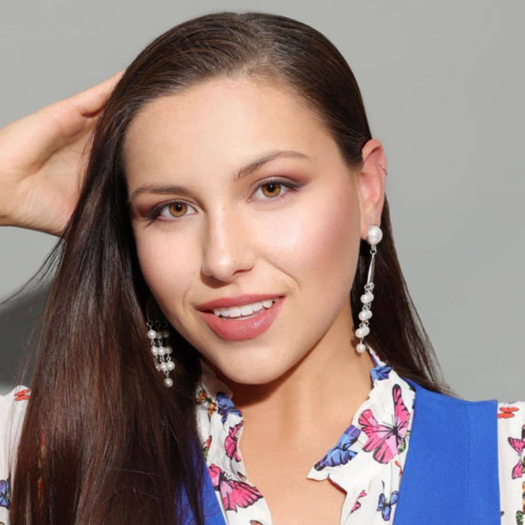 Smiling woman with long hair and earrings