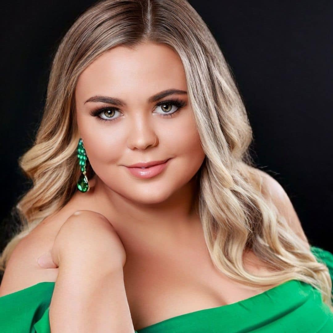 Woman in green dress with green earrings