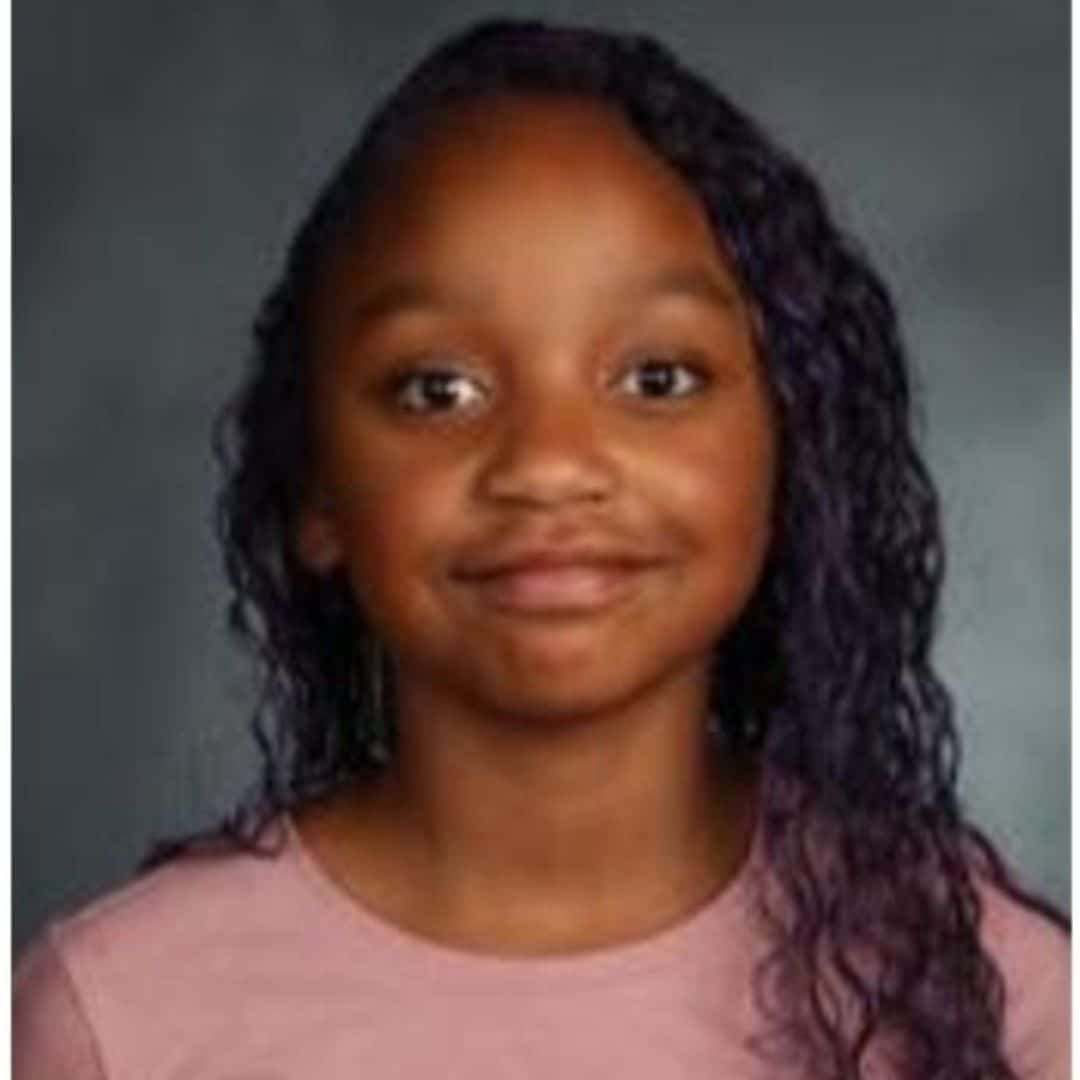 Young girl with curly hair smiling