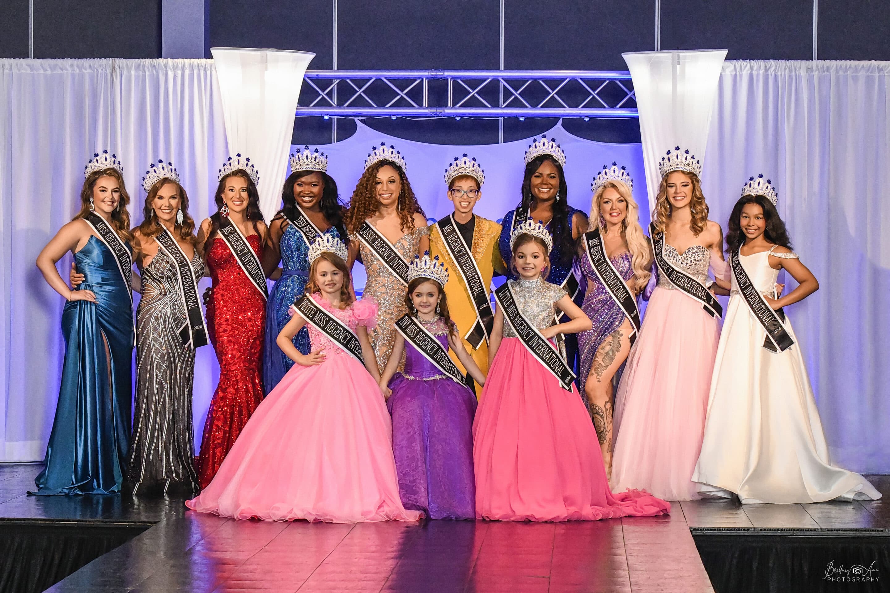 Beauty pageant winners posing on stage.